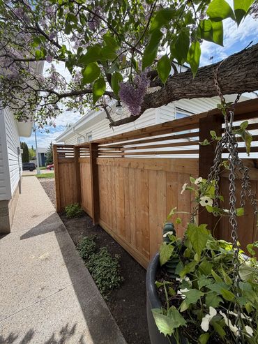 Custom full privacy fence with a horizontal lattice.