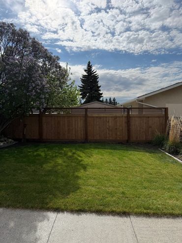 Custom full privacy fence with a horizontal lattice.