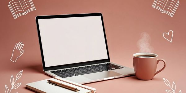 Laptop, notebook, pen, and steaming coffee cup on a pink desk.