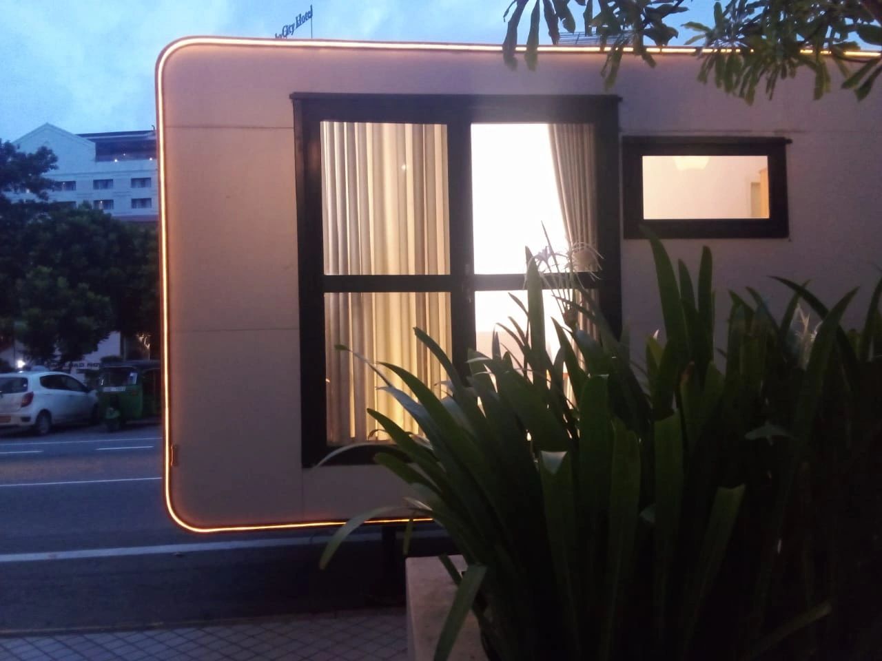 Grand Rover luxury caravan movable hotel suite exterior with panoramic glass door and ambient lighti