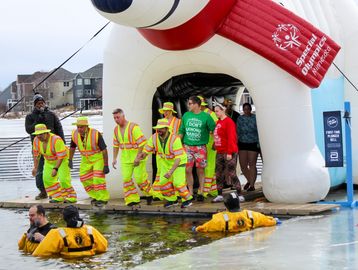 Anoka County Highway crew plunging with the Northern Lights delegation.