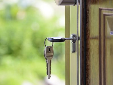 "keys in door of a new house"