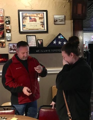Presenting her with the Dog Tags of her fallen father.