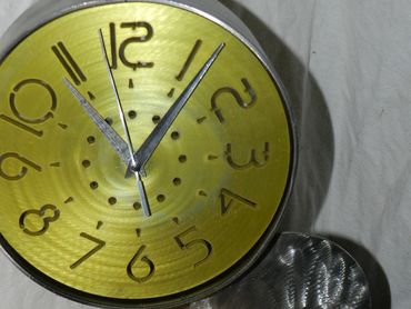 Solid Stainless steel clock sculpture with anodizes aluminum face,  Very contemporary and unique clo