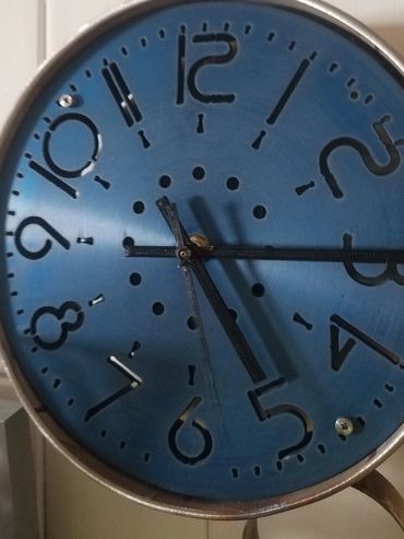 Stainless steel Clock frame with blue anodized aluminum face.  Very unique design and modern look.