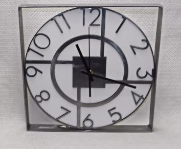 A polished steel mantle clock or wall hanging clock.  Sealed in gloss clear. 