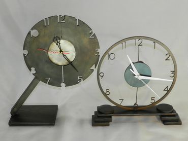 Positive and negative waterjet cut steel clocks. blued and sealed.  
