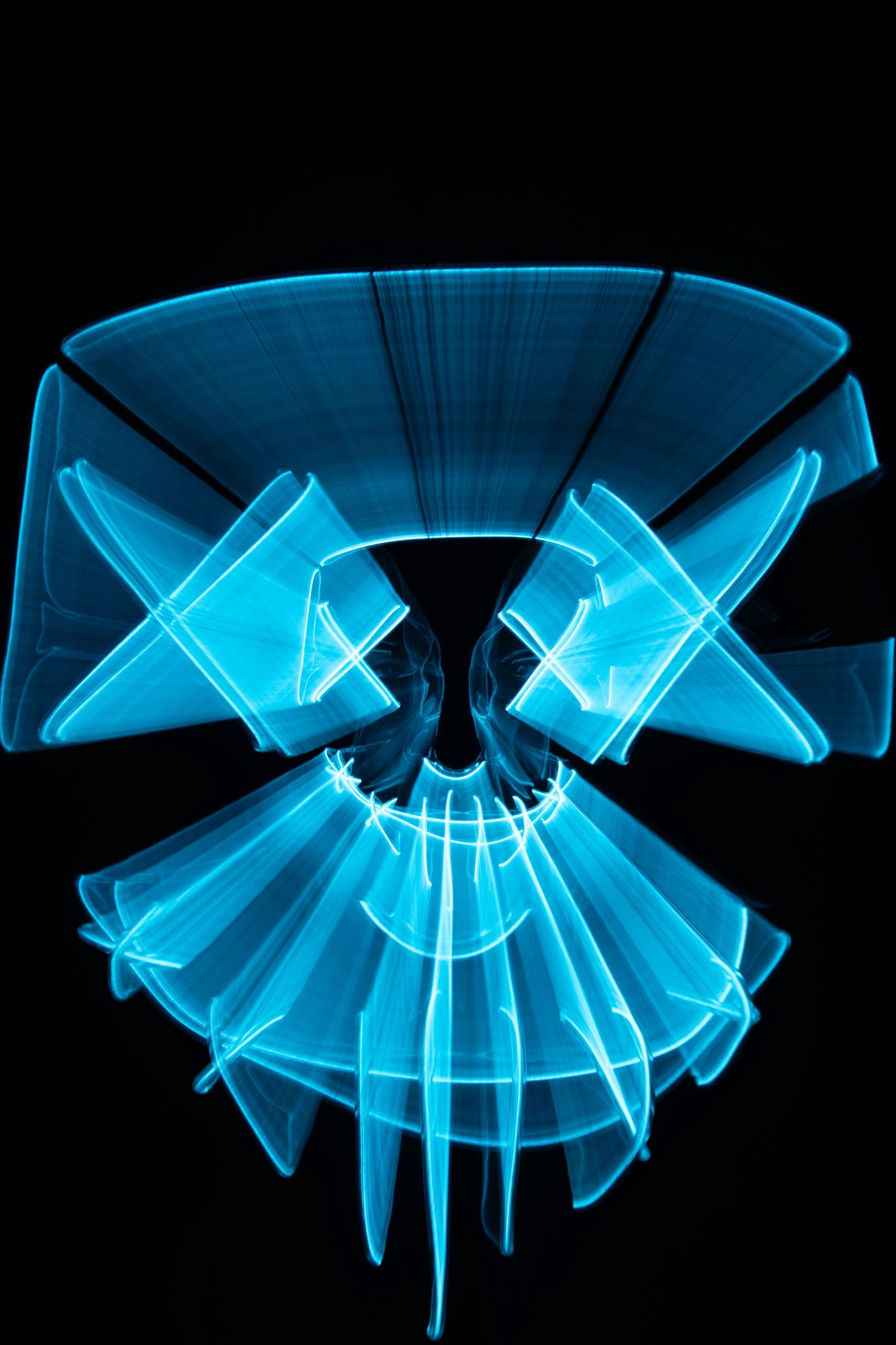 Blue light painting creating a skull and crossbones effect.