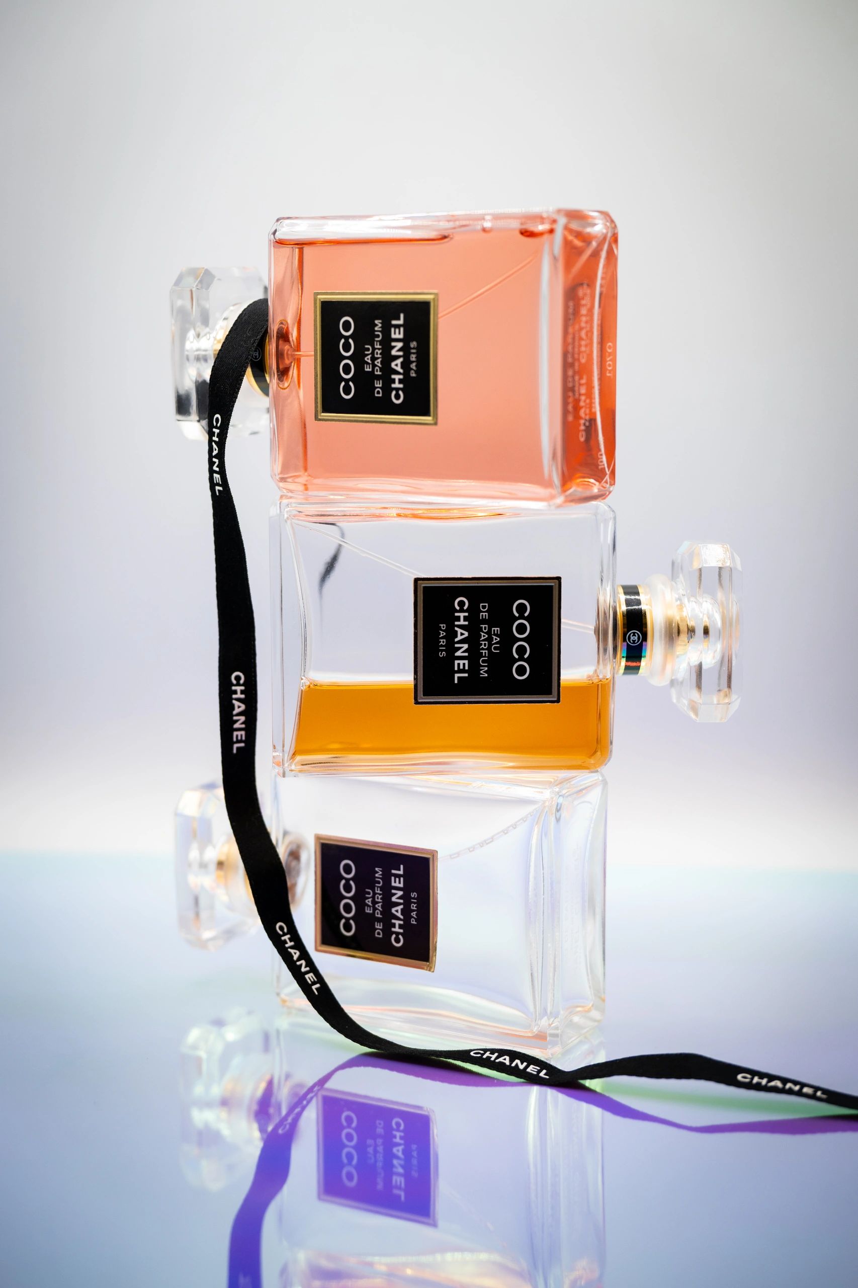 Two elegant Chanel Coco Eau de Parfum bottles with contrasting liquid colors.