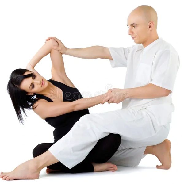Therapist assisting woman with stretching exercise.