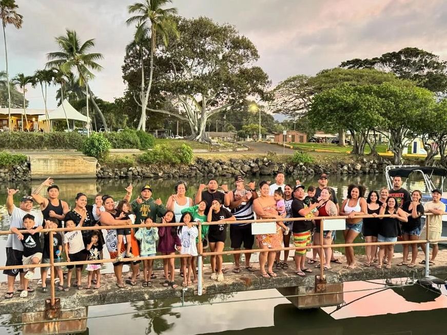 Large group of people posing on a dock.