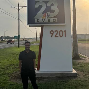 Former University of West Georgia student Aurie Johnson standing in front of the KVEO 23 news sign.
