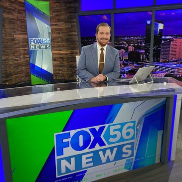Former University of West Georgia student Bode Brooks pictured sitting at the news desk of FOX 56 