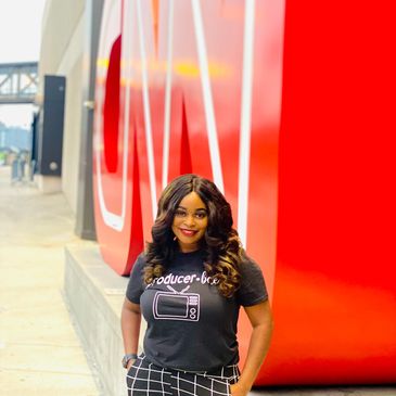 Former UWG student Gabrielle Nelloms standing n front of the CNN sign with hands in pockets.
