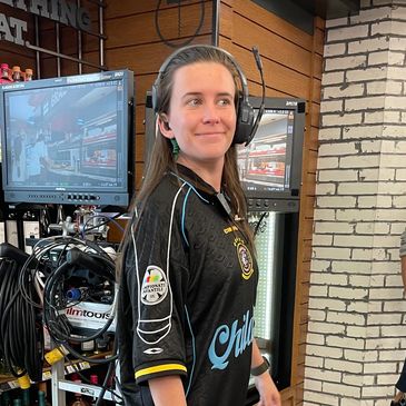 Former University of West Georgia student Camrynn Kiley stands in a studio wearing a headset.
