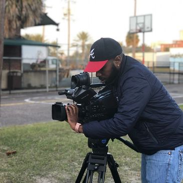 Former University of West Georgia student Phillip Smith pictured adjusting a field camera.
