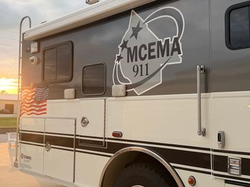 MCEMA 911 emergency vehicle at sunset.