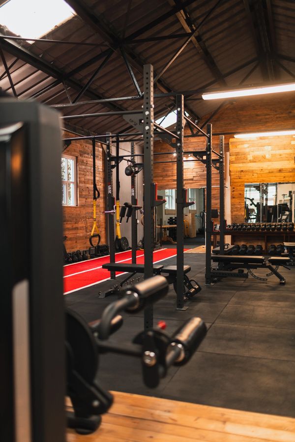 Modern gym with wooden walls and fitness equipment.