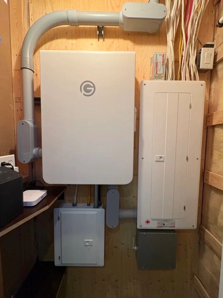 Electric panel and equipment installed neatly on wooden wall.