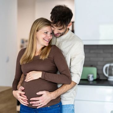 Expecting parents celebrating pregnancy after seeking a reproductive therapist in Denver