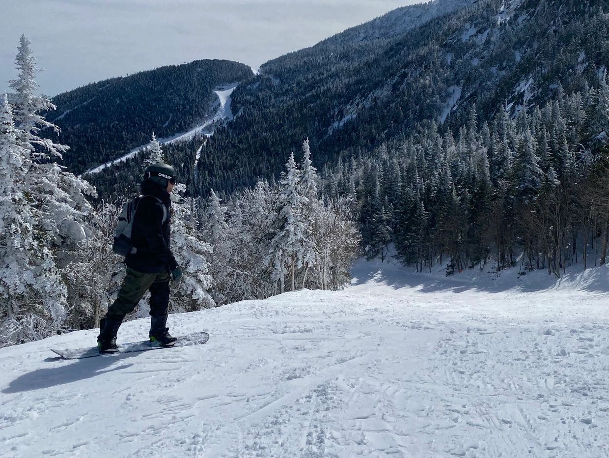Snowboarding down a mountain slope in winter, representing freedom, movement, and outdoor adventure