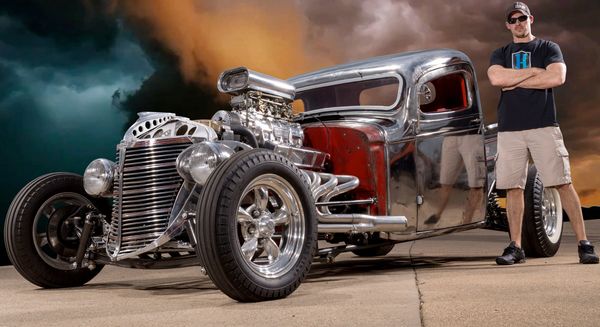 Owner Rick Hammer standing next to a hot rod.