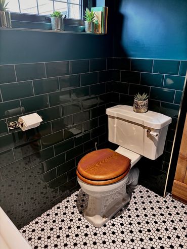 Burlington toilet with green metro wall tiles black and white mosaic floor tiles 