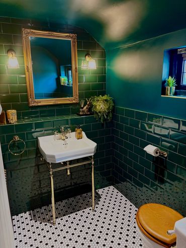 Burlington basin and Burlington toilet with green metro tiles black and white mosaic floor tiles 