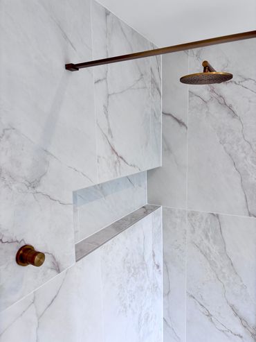 This is a Lusso Stone Concealed Shower Valve and the walls tiles are Quorn Stone Carrara Rosa Pink 