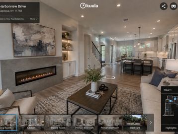 Modern open-concept living room and kitchen with a fireplace and cozy seating.