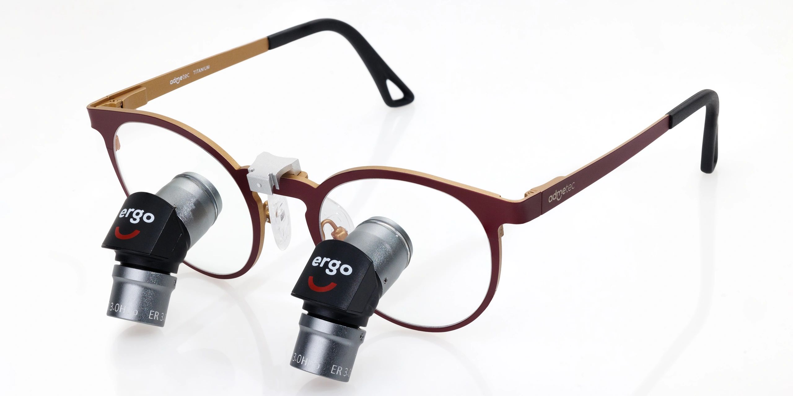Close-up of eyeglasses with attached magnifying lenses for detailed viewing.