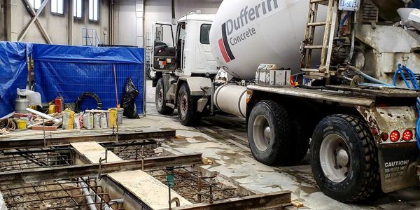 Cement truck in a facility to pour concrete for a machine base