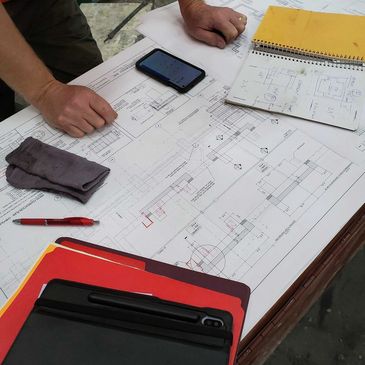 A construction professional reviewing technical drawings for a commercial concrete project