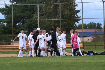 Youth soccer team gathering on the field before a game.