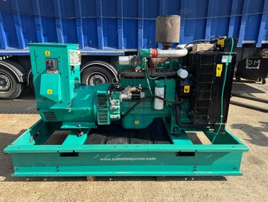 Green industrial Cummins power generator set on a metal base.