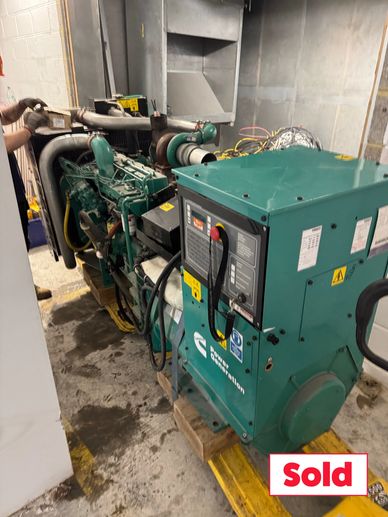 Industrial generator set in a maintenance room with a 'Sold' label.