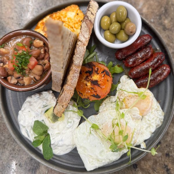 Mediterranean Breakfast: Grilled Sojok, Tzatziki, Halloumi, Foul, Olives, Sunny Eggs, Sourdough