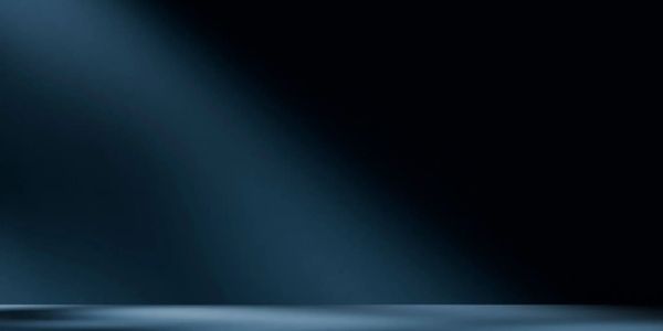 Empty dark stage with blue spotlights creating a moody atmosphere.
