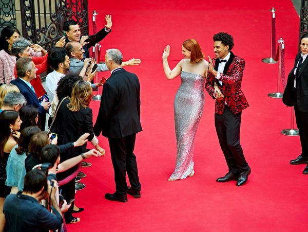 celebrities waking on a red carpet 