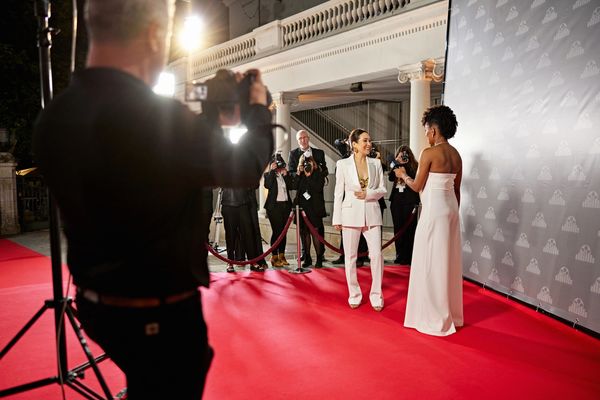 a woman in white gown on red carpet 