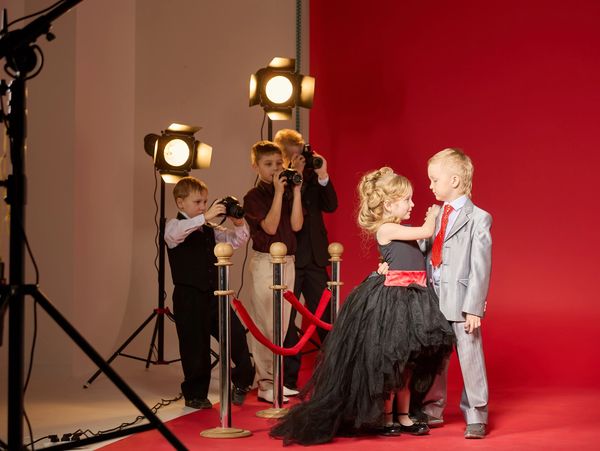 a boy and girl on red carpet 