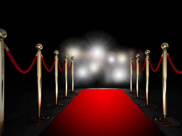 a red carpet and lights in background