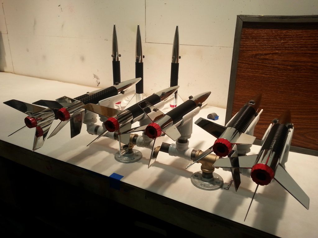A selection of rockets, silver color with white and red details.