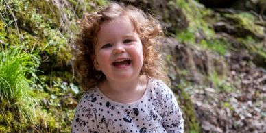 laughing two year old hiking in nature