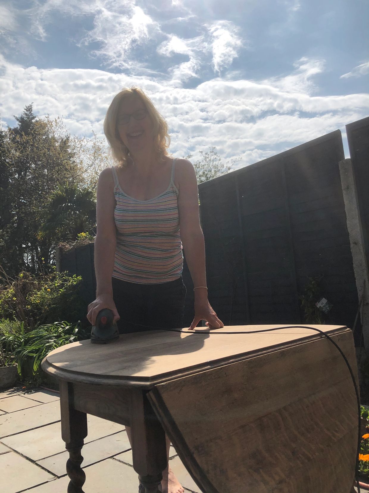 This is me, sanding a table in my garden. 