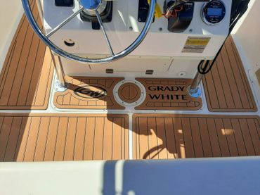 teak and black maxx tread flooring on a grady white boat with teak lines and custom logos. EVA/PE