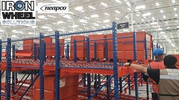 Security agent inspecting industrial storage racks in a warehouse.