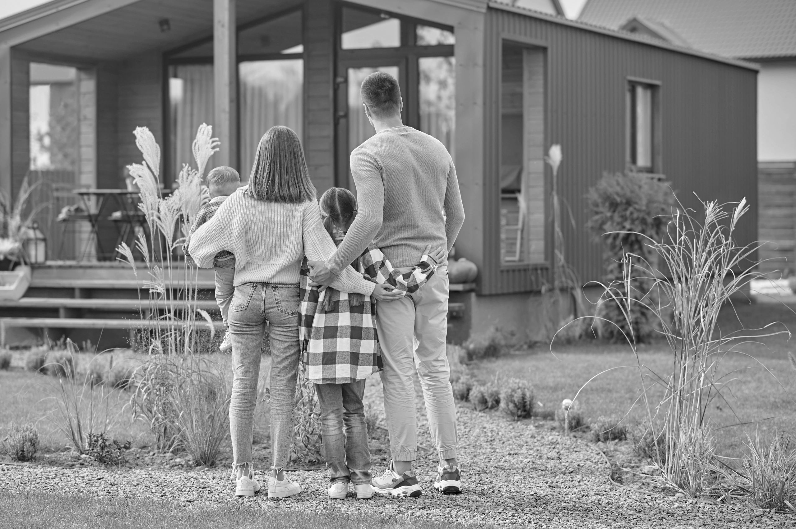 Happy First time home buyers admire their new home, celebrating homeownership & family living.