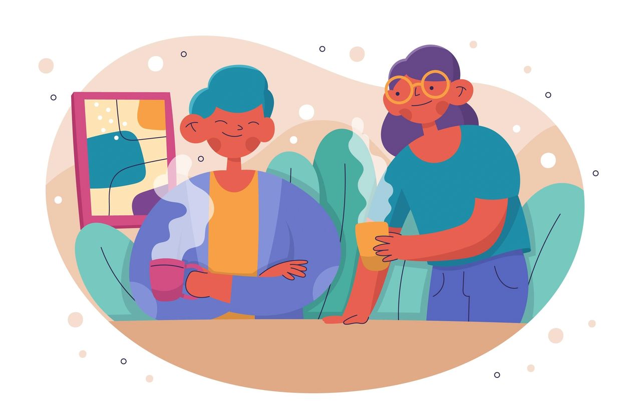 Two people enjoying hot drinks together in a colorful setting.