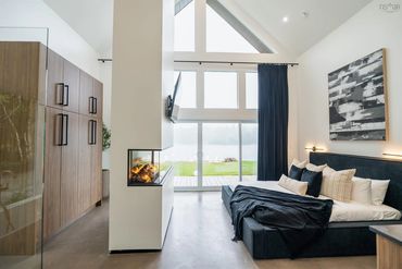 Modern interior photos of this beautiful Lux air B&B rental bedroom with fireplace